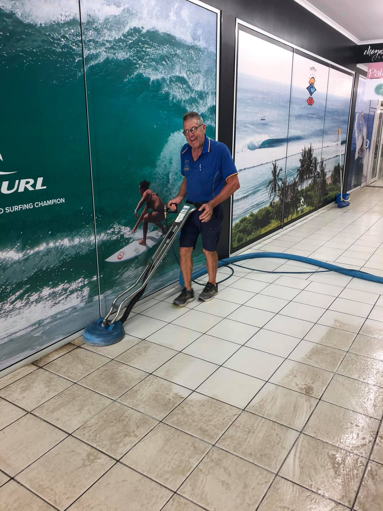Worker Using Buffer to Clean Tiled Floor — Cleaning Company in Bundaberg
