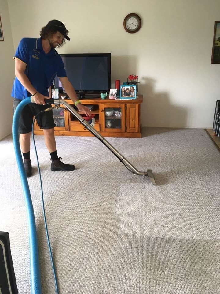 Male Worker Vacuuming Carpet — Cleaning Company in Bundaberg