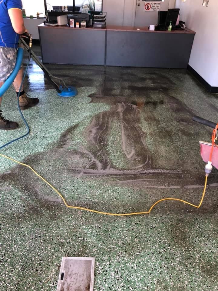 Cleaner Using Buffer on Green Floor — Cleaning Company in Bundaberg