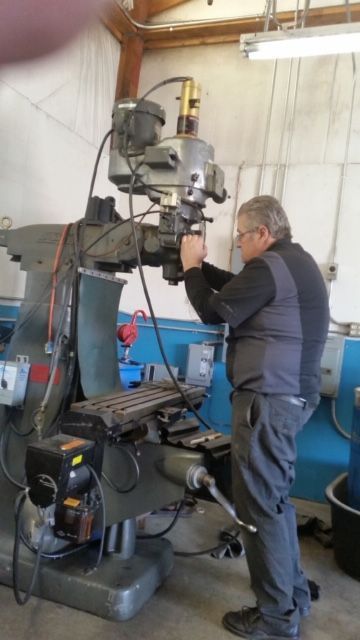 A man is working on a machine in a workshop