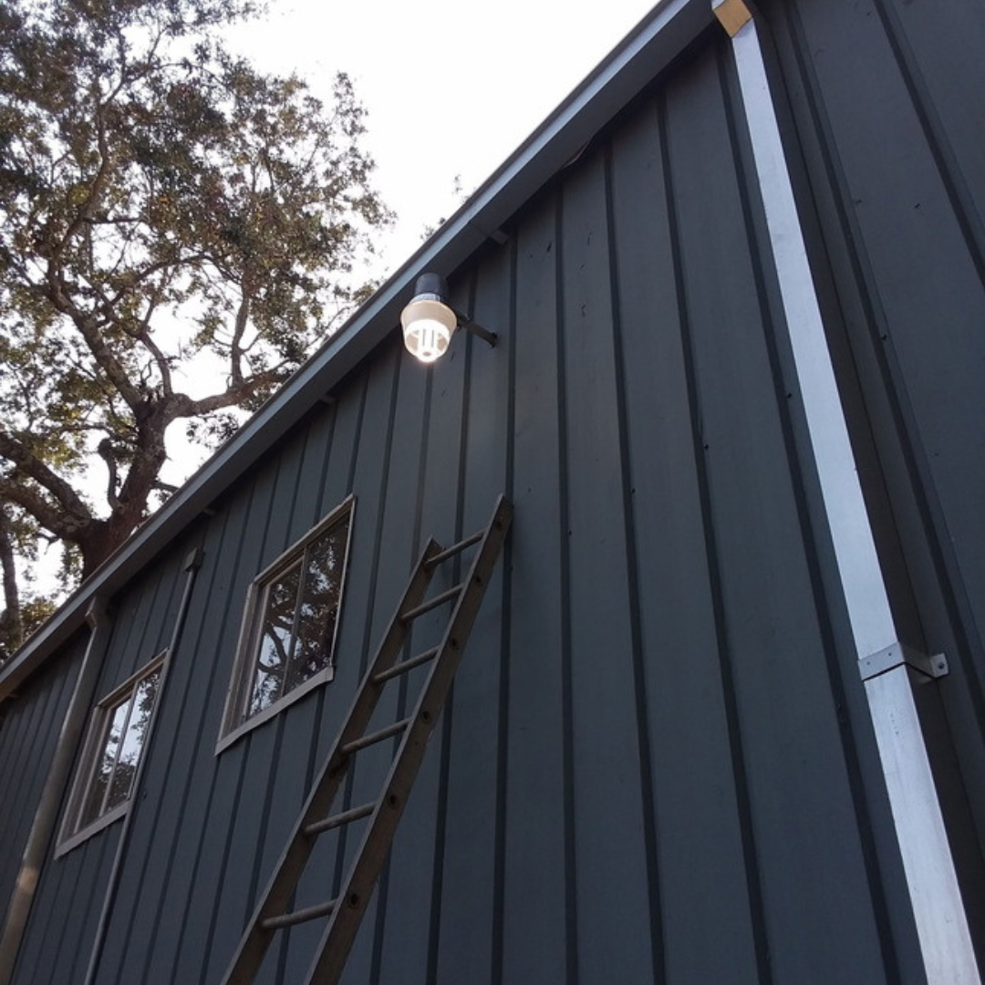 A man is working on a pipe system in a building.