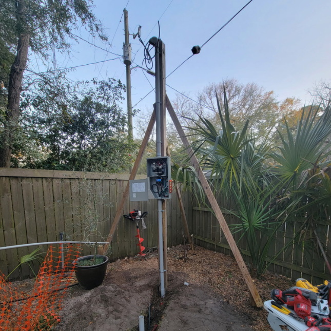 A person is using a multimeter to measure voltage