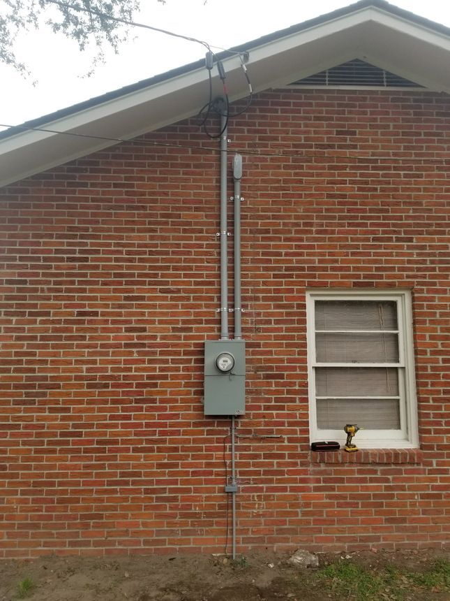 Two light bulbs are hanging from the ceiling in a dark room.