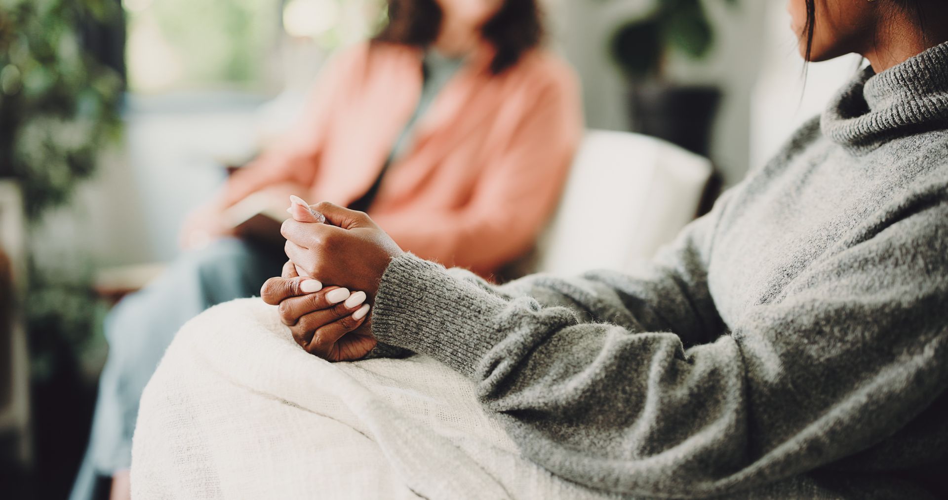 Close-up of the hands of a woman on a sofa for anxiety counselling services.