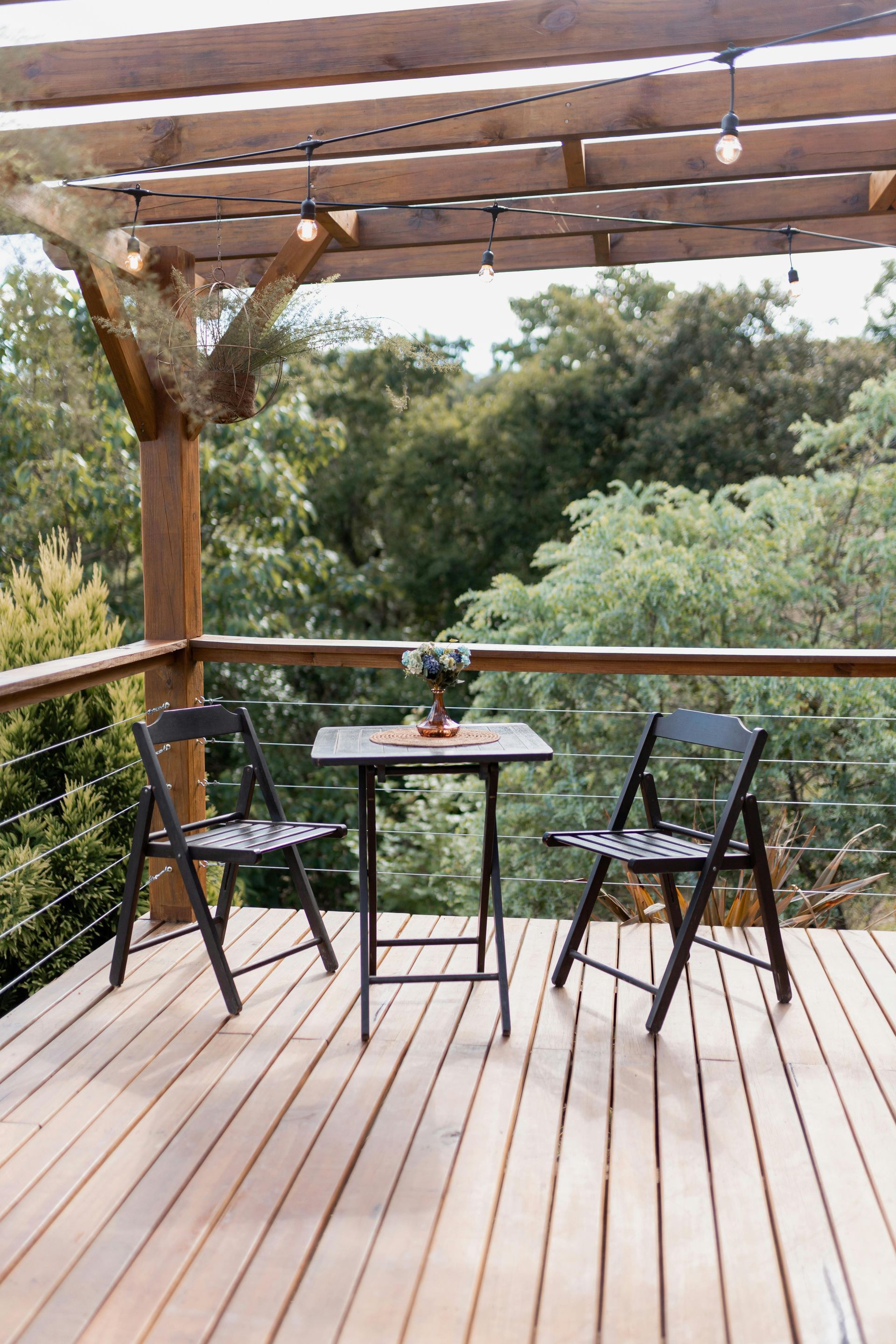A Wooden Deck With Stairs Leading Up to It Next to a Brick Wall — Portstyle Constructions in Surfers Paradise, QLD
