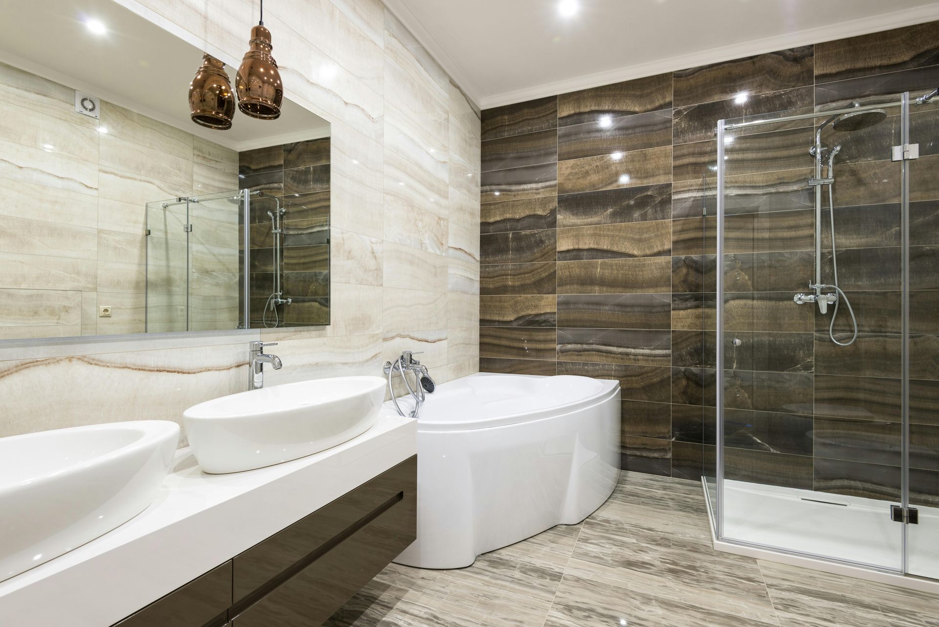 A renovated bathroom with new shower screens, bathroom fixtures and vanities.