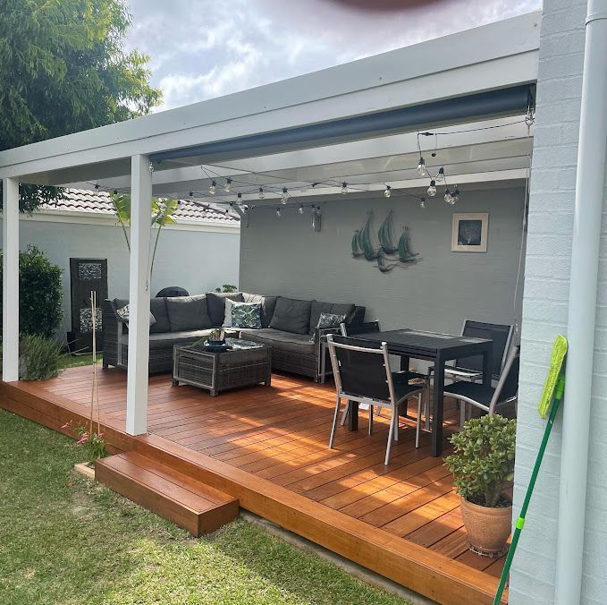 A Patio With a Couch, Table and Chairs Under a Canopy — Portstyle Constructions in Broadbeach, QLD