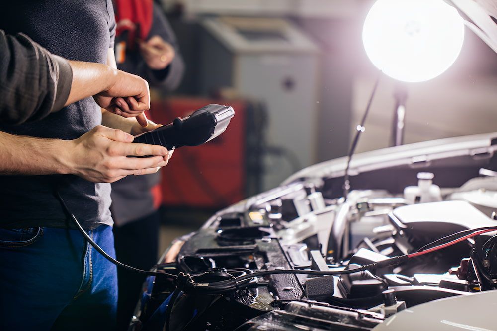 Two Men Are Working On A Car In A Garage — Cam Duffy Autos In Atherton, QLD