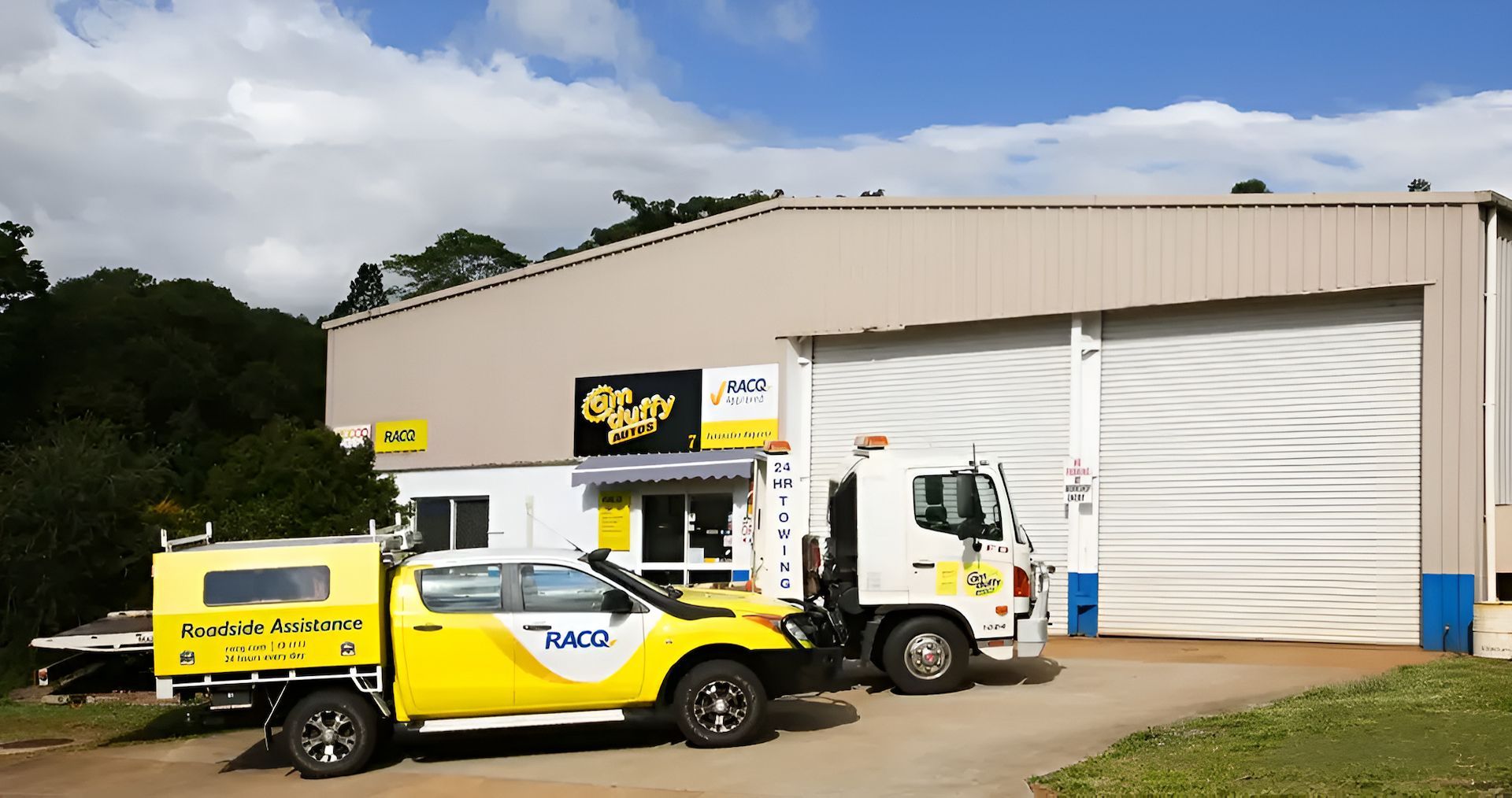 Two Racq Trucks Are Parked In Front Of A Building — Cam Duffy Autos In Mareeba, QLD