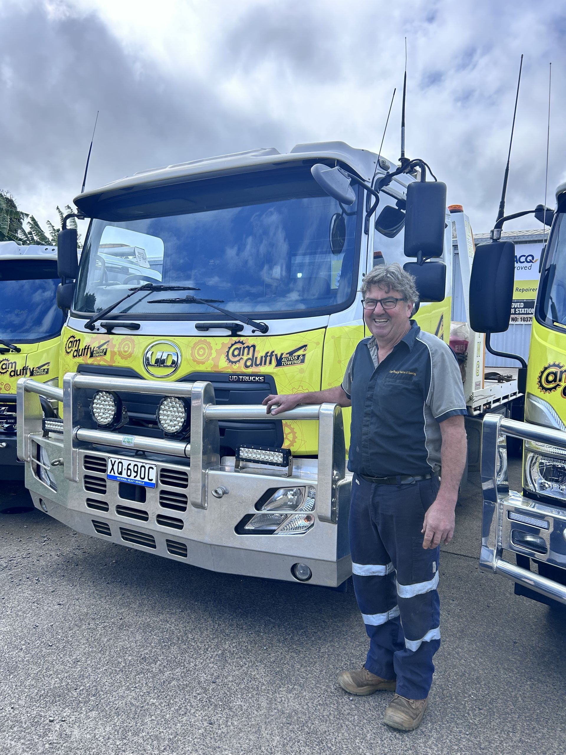 Man standing in front of yellow car— Cam Duffy Autos In Atherton, QLD
