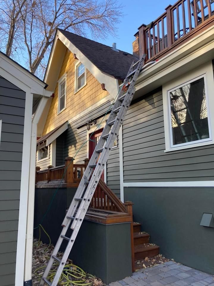 A ladder is leaning against the side of a house.