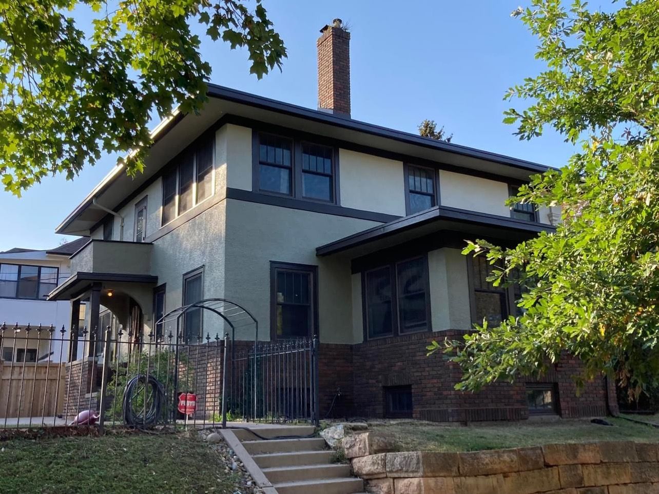 A large house with a chimney on top of it