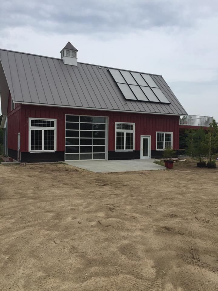 A red barn with solar panels on the roof