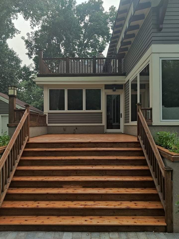 A wooden deck with stairs leading up to it