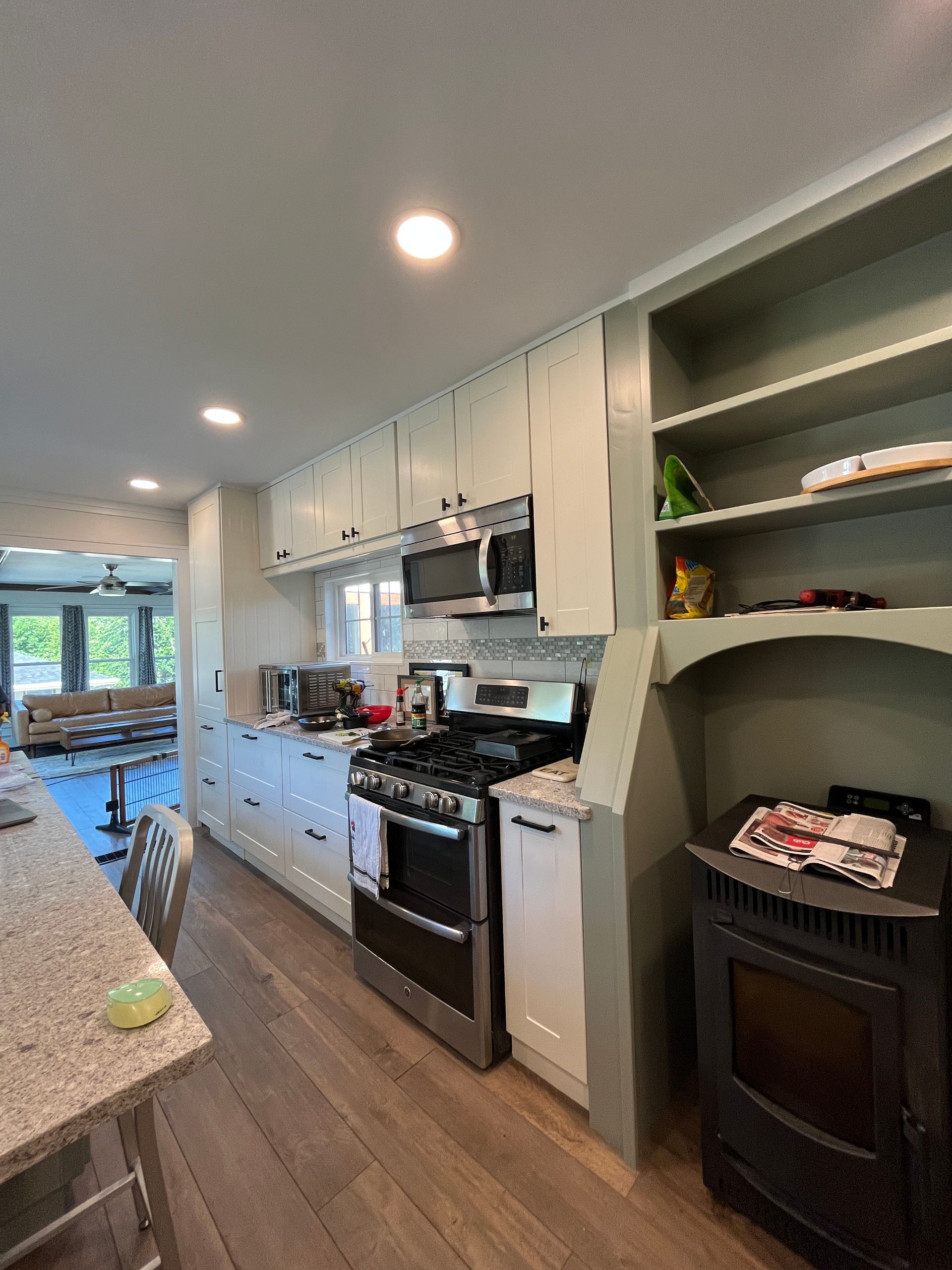 A kitchen with a stove , microwave , and refrigerator.