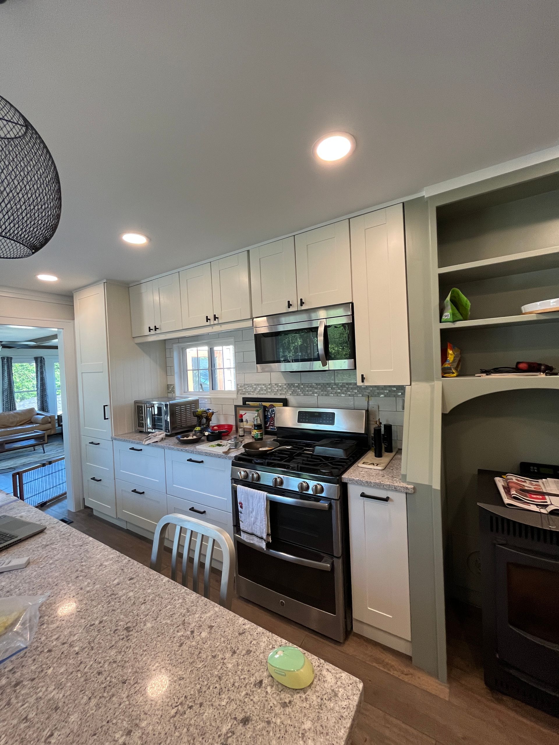 A kitchen with white cabinets and stainless steel appliances