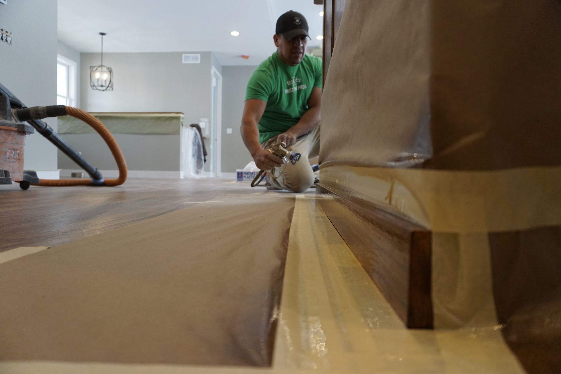 A man is sanding a piece of wood with a sander.