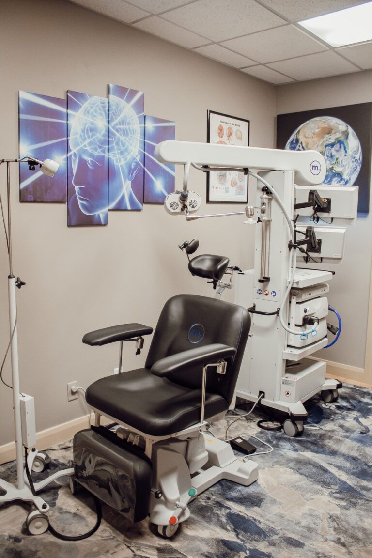 A room with a chair and a microscope in it.