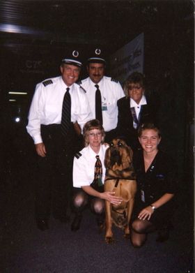 A group of people posing for a picture with a dog