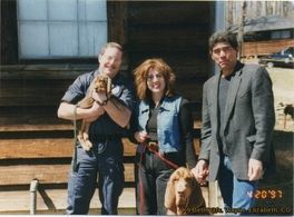 A group of people posing for a picture with a dog