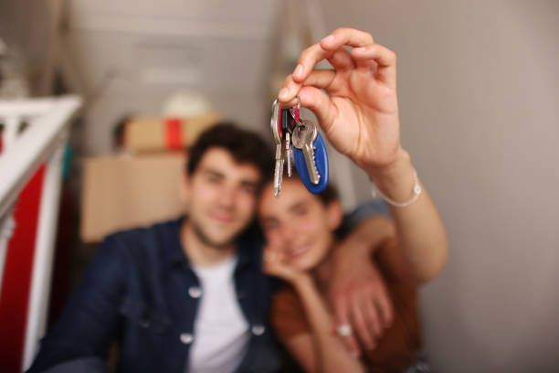 young couple holding keys