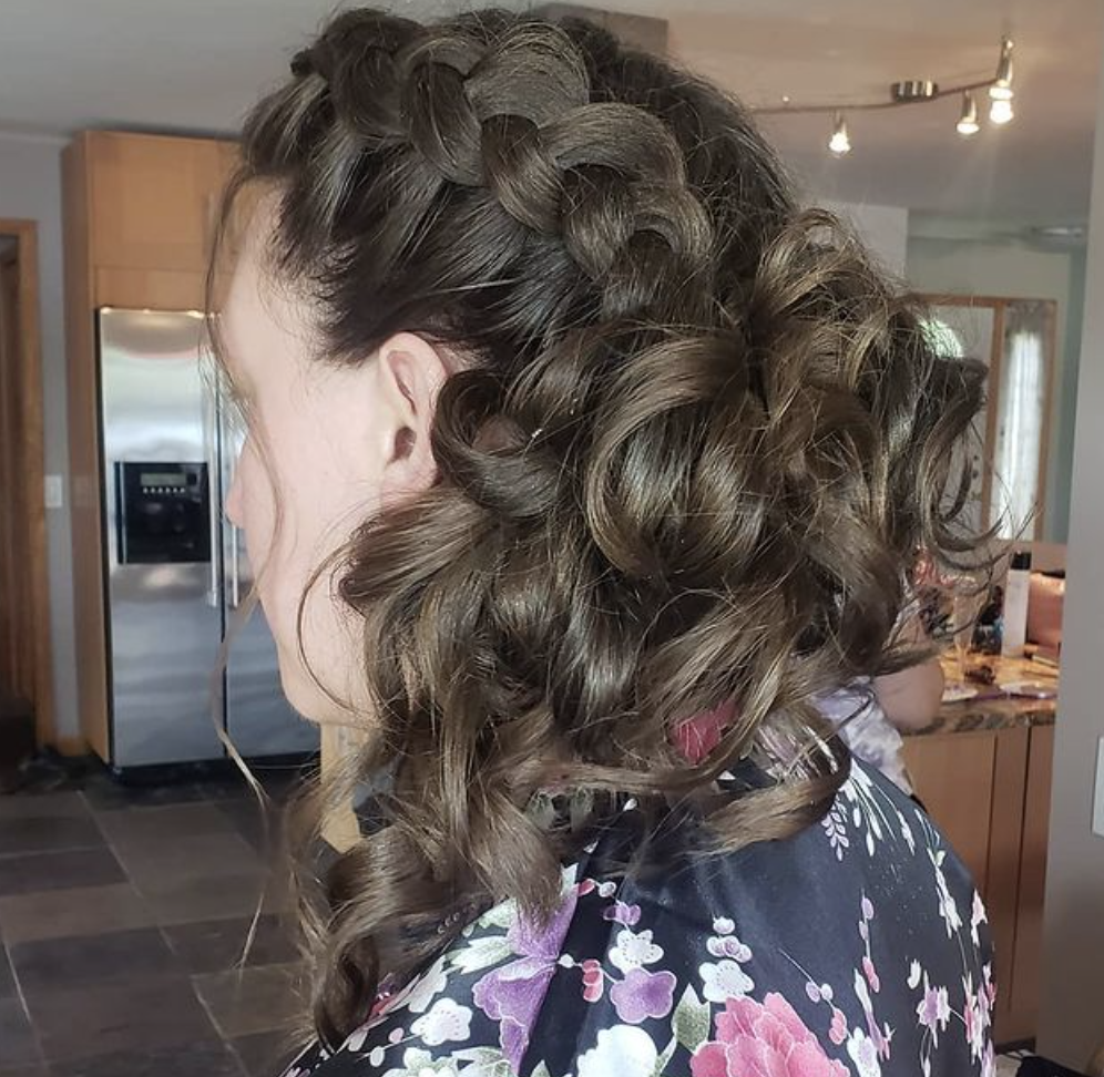 A woman with a braid in her hair is wearing a floral robe.