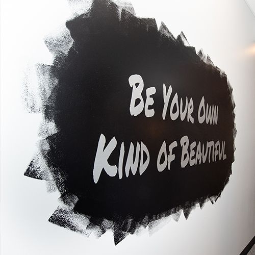 A black and white sign that says be your own kind of beautiful