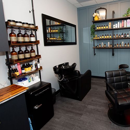A hair salon with a sink and a mirror