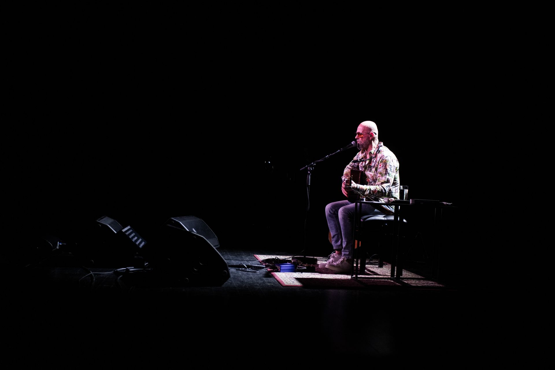 Bubbi Morthens performing live at Stapi, passionately singing on stage with dramatic red lighting.