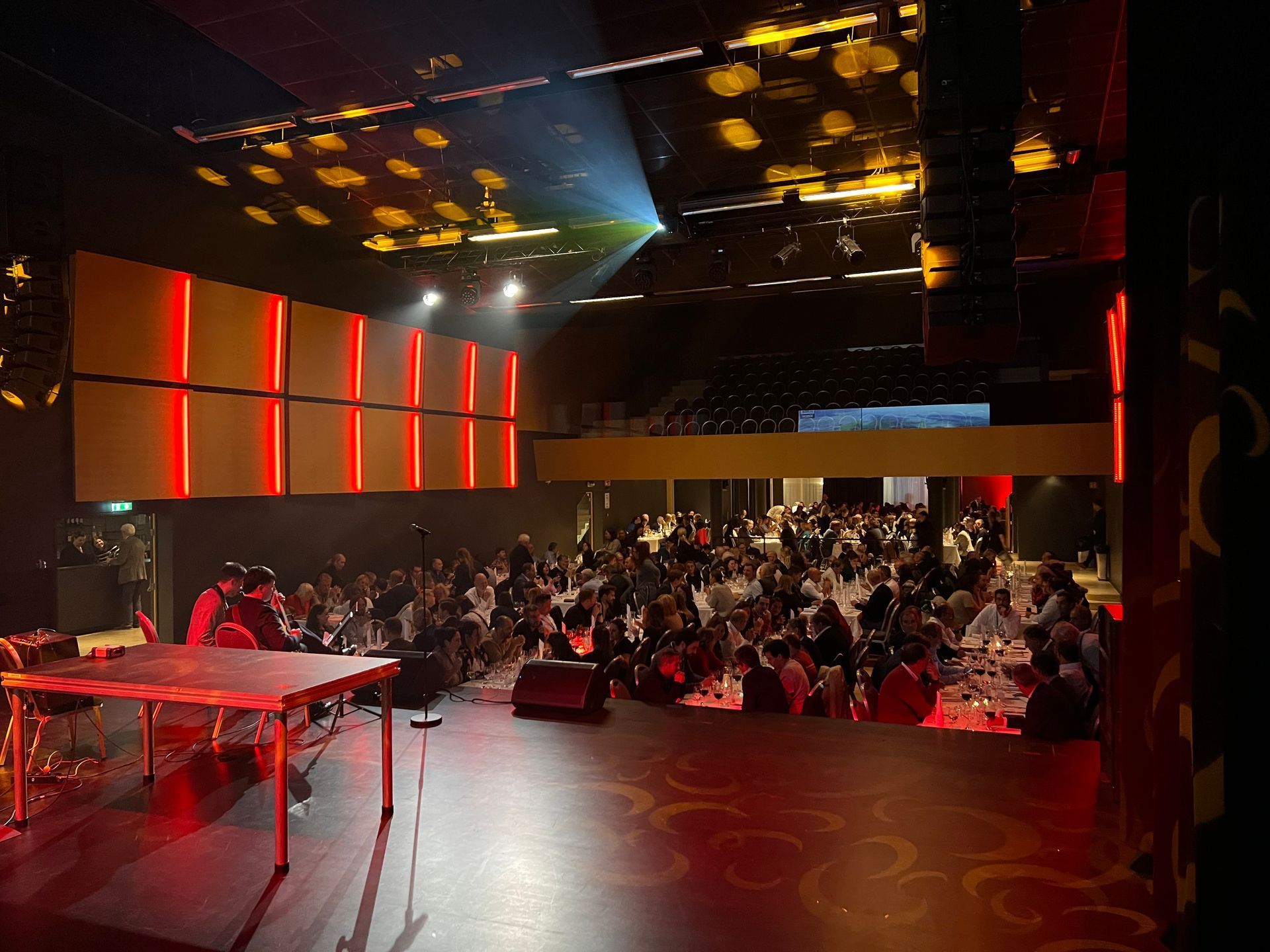 Guests seated at long tables during a formal gala dinner in Stapi event hall.