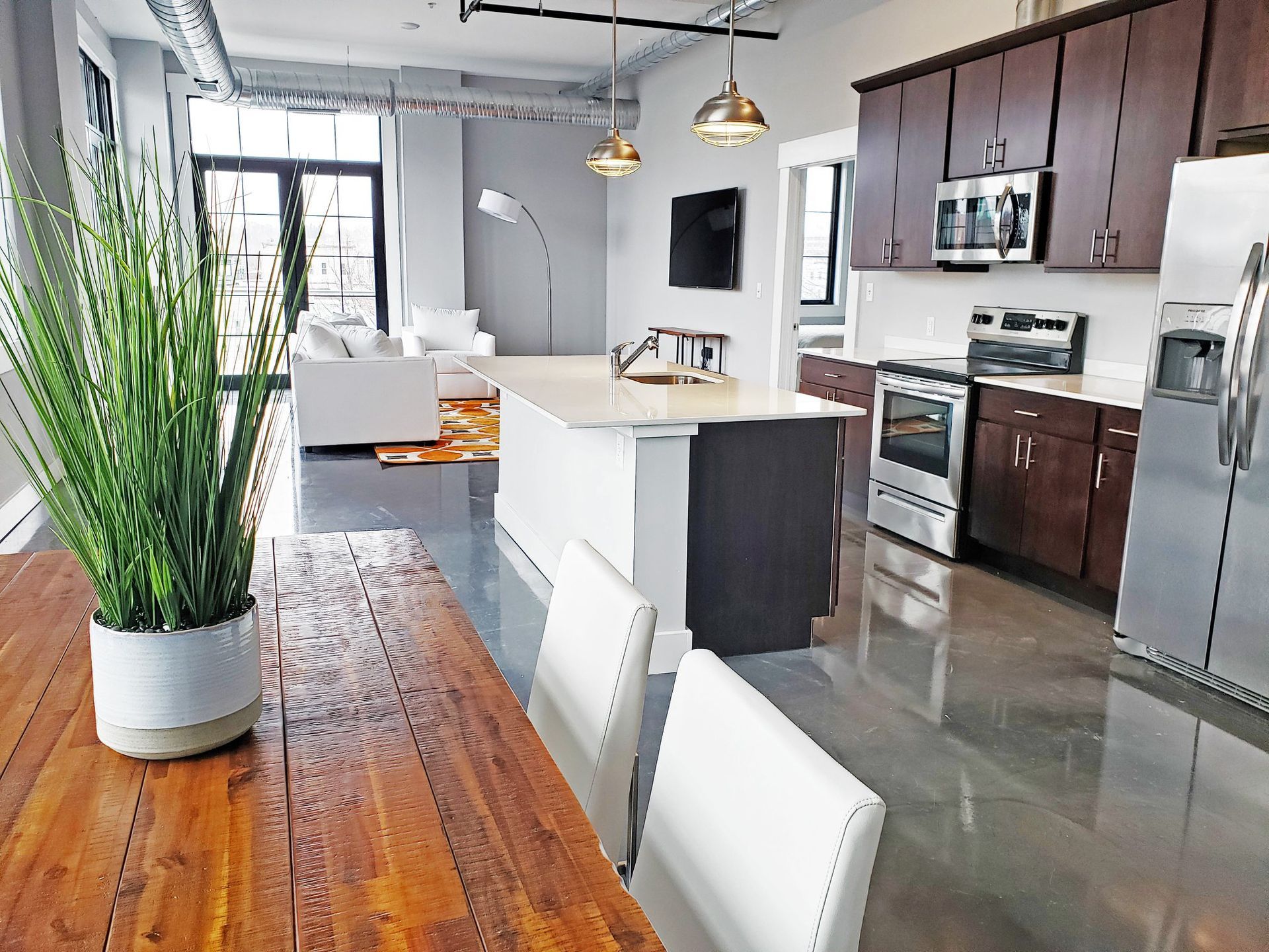 A kitchen with stainless steel appliances and wooden cabinets