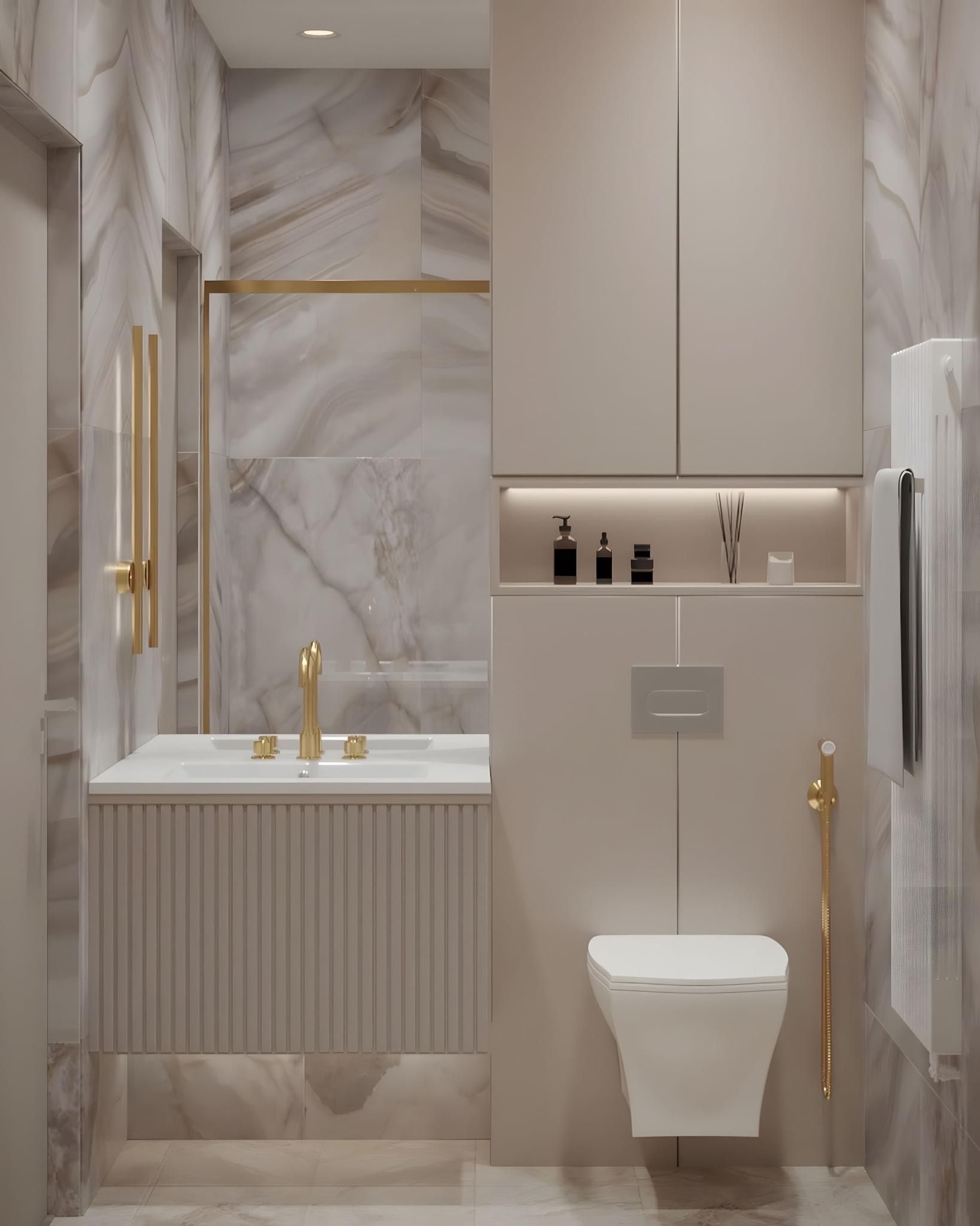 Elegant beige and gold bathroom; marble walls, vanity, and toilet, with built-in storage.
