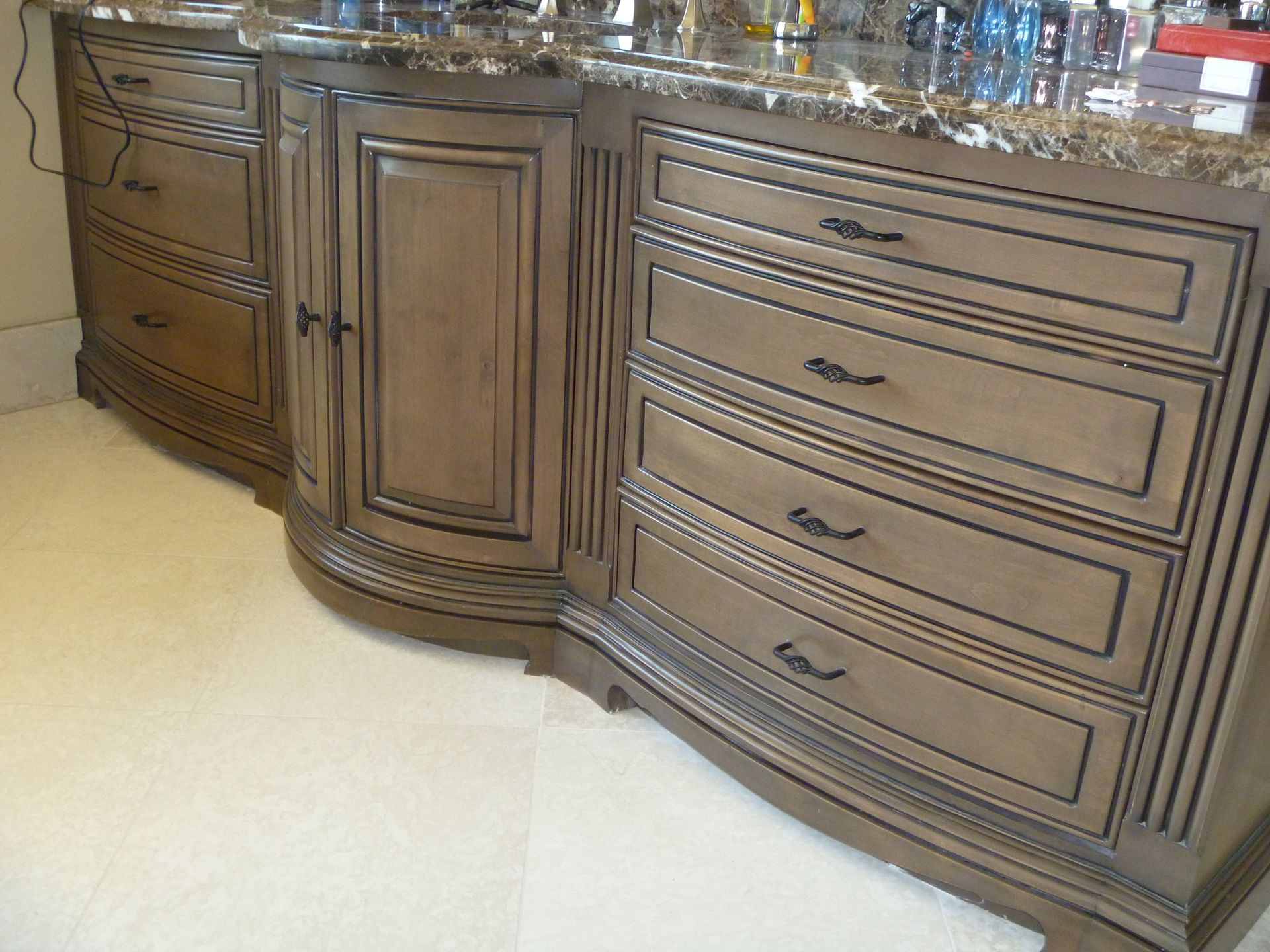 Kitchen with dark wooden cabinets, stainless steel appliances, and tile backsplash.