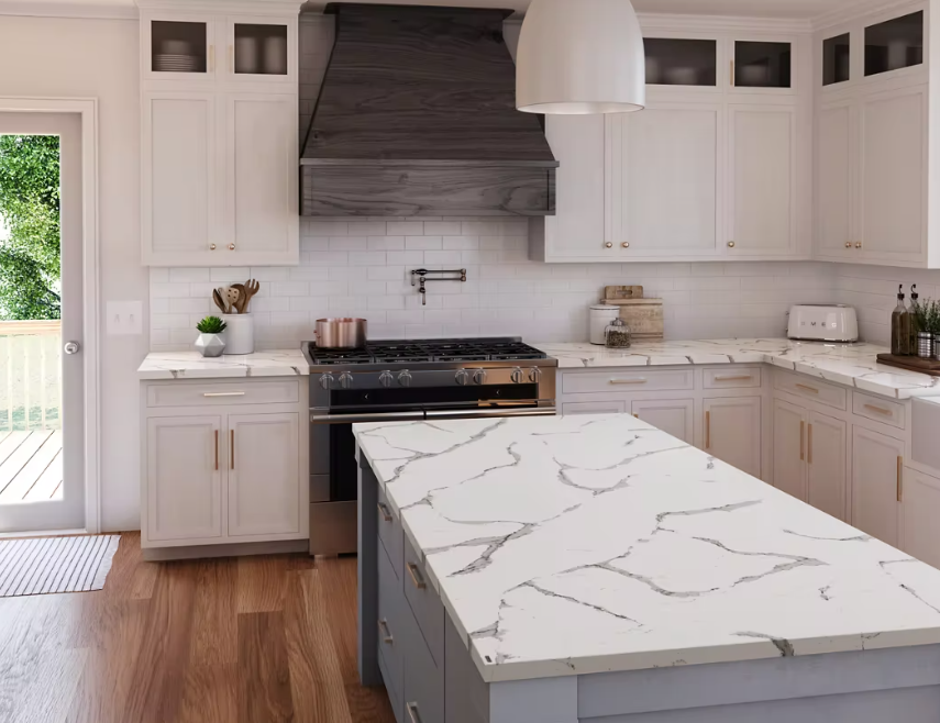 Kitchen with white cabinets, marble countertops, stainless steel appliances, and a gray island.