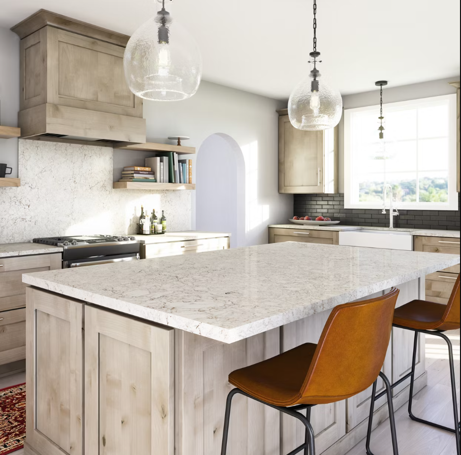 Kitchen with light wood cabinets, white countertops, and bar stools.