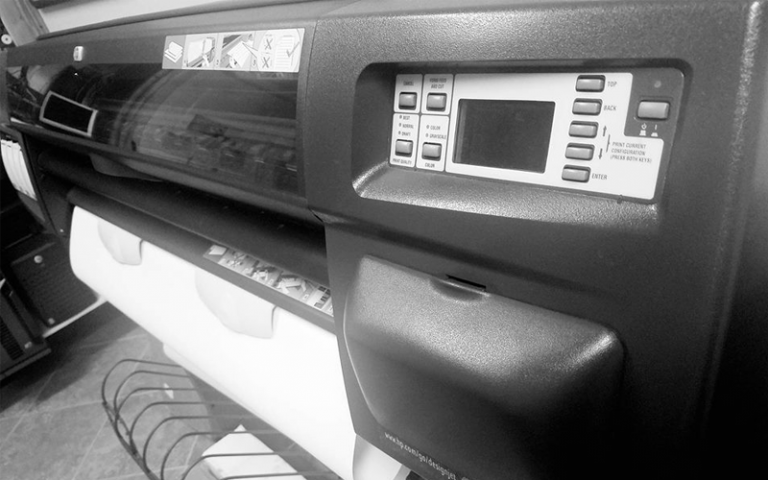 Monochrome printer control panel with buttons and a display screen.