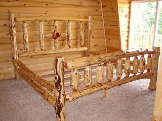 A bed made out of logs in a log cabin.