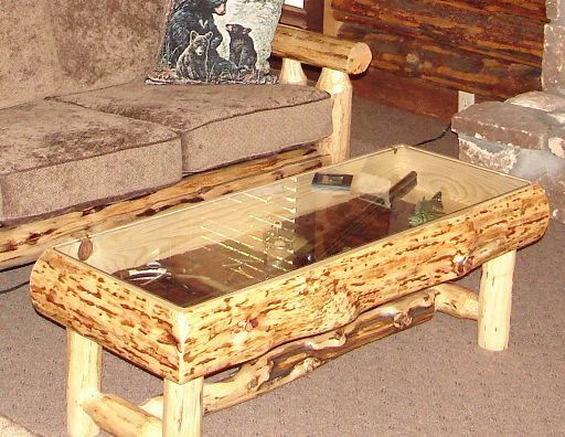 A log coffee table with a glass top in a living room
