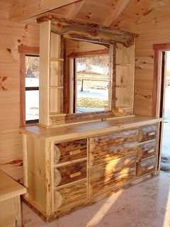 A wooden dresser with drawers and a mirror in a wooden cabin.