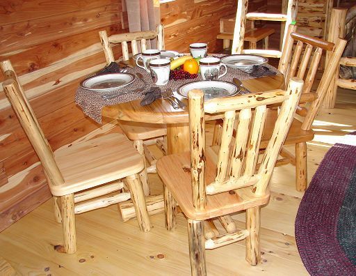A wooden table with plates and cups on it