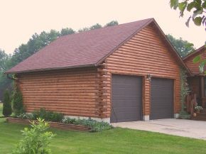 A log cabin garage with two garage doors and a red roof.