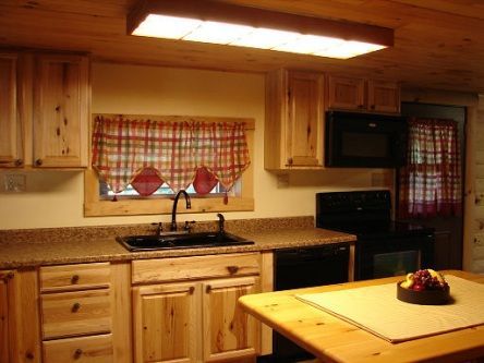 A kitchen with wooden cabinets and granite counter tops