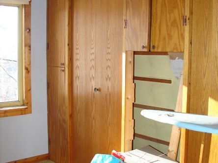 A room with wooden cabinets and a window