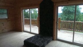A living room with sliding glass doors and a fireplace.