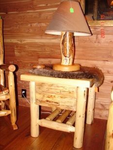 A wooden table with a lamp on top of it