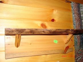 A wooden shelf with a green sticker on it