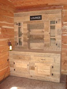 A wooden cabinet with a sign that says lounge on it