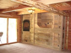 A living room with a wooden fireplace and sliding glass doors.
