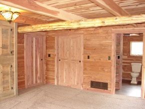 An empty room with wooden walls and a toilet
