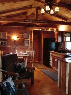 A living room and kitchen in a log cabin
